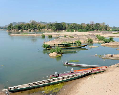 Traditional boat crossing Mekong River to islands